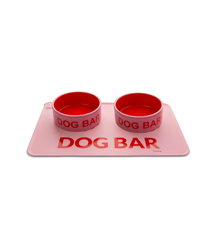 Tappetino per Ciotola Dog Bar rosa con due ciotole rosse posizionate sopra.