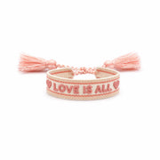 Braccialetto in tessuto con scritta Love is All in rosa.