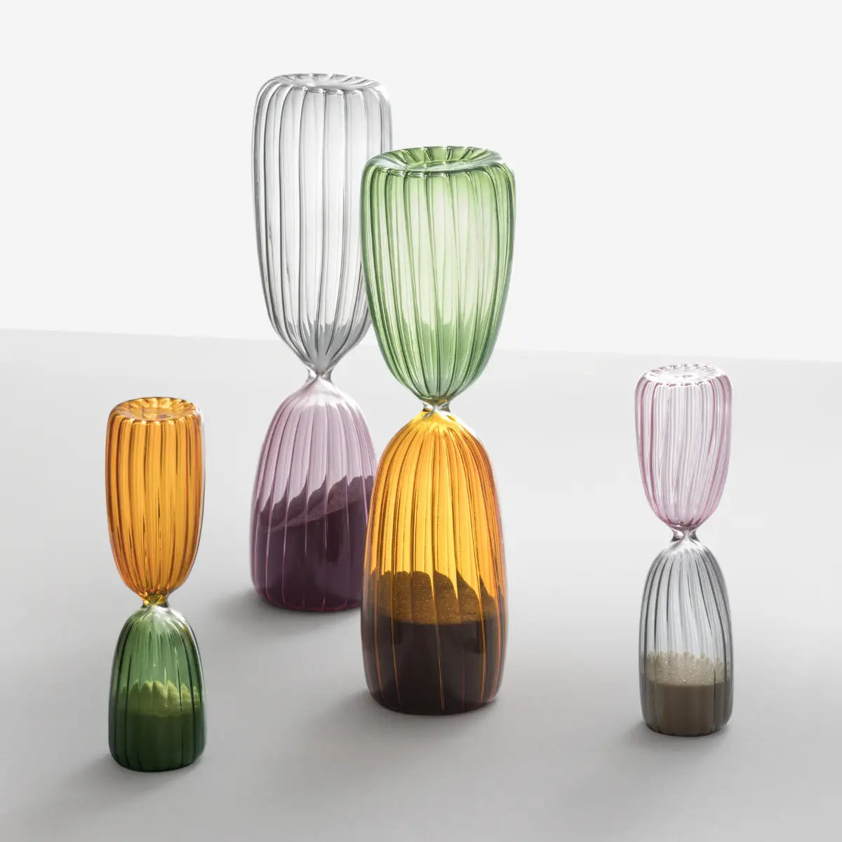 4 Clessidre della collezione Times di Ichendorf appoggiate su un tavolo. Sono presenti in entrambe le grandezze disponibili, da 5 minuti e 15 minuti