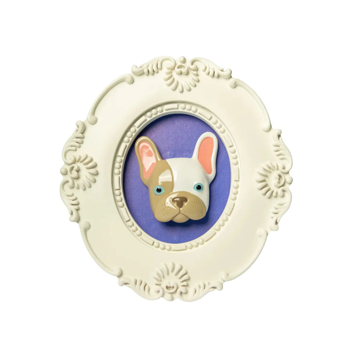 Cornice bianca di forma ovale con il volto di un bulldog in rilievo con gli occhi azzurri e a macchie bianche e marroni su sfondo viola. L'immagine è su sfondo bianco.