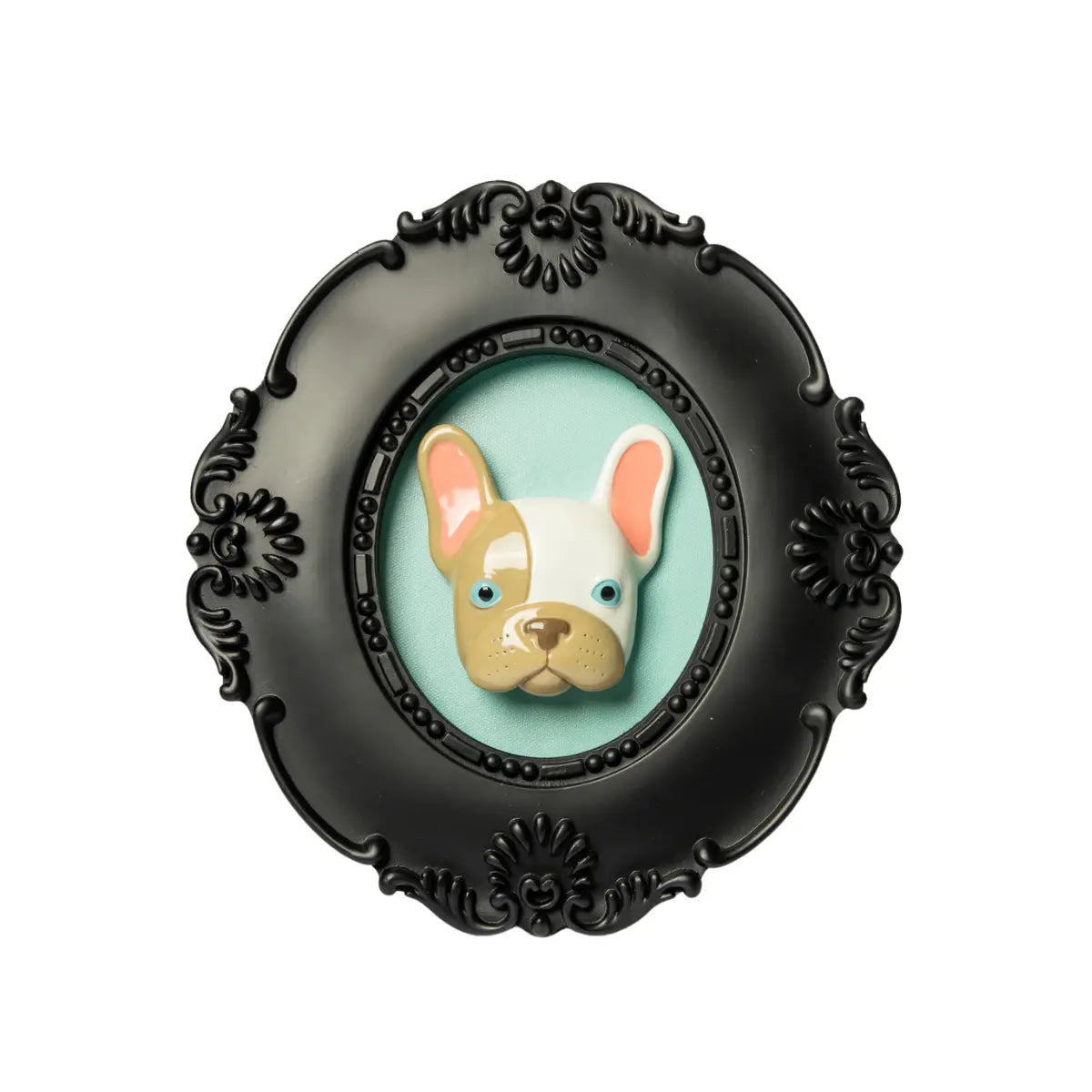 Cornice nera di forma ovale con il volto di un bulldog in rilievo con gli occhi azzurri e a macchie bianche e grigie su sfondo azzurro. L'immagine è su sfondo bianco.