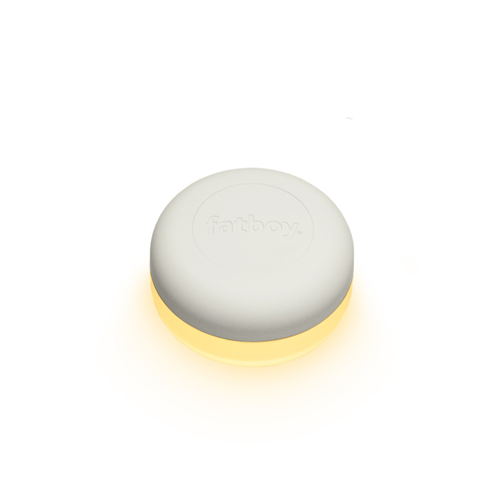Luce ricaricabile accesa. Parte sopra bianca, sotto trasparente. Luce bianca. Sfondo bianco