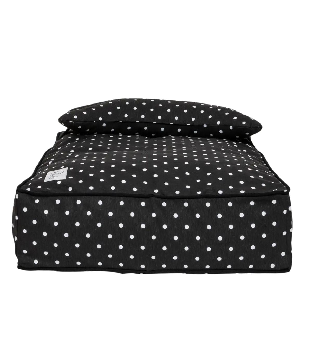 Cuccia letto per cani nero con pois bianchi e cuscino a forma di osso. Sfondo bianco