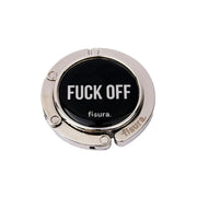 Gancio porta borsa con scritta nera "Fuck off" richiuso. In metallo 