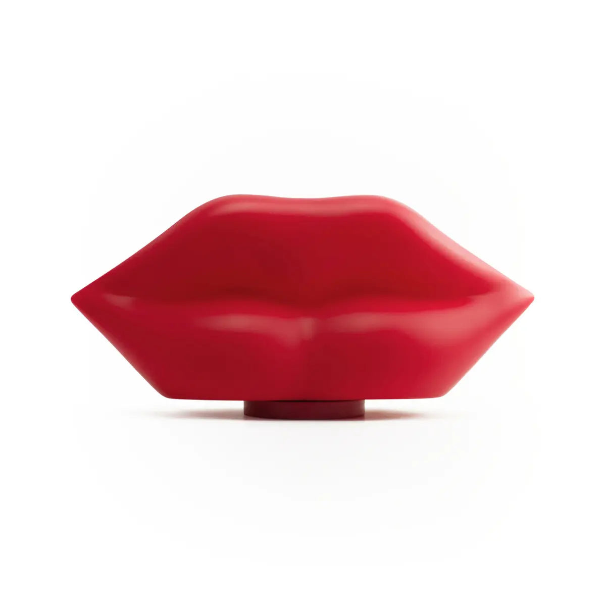 Lampada da tavolo rossa a forma di labbra. Appoggiata su una base di ricarica wireless. Sfondo bianco