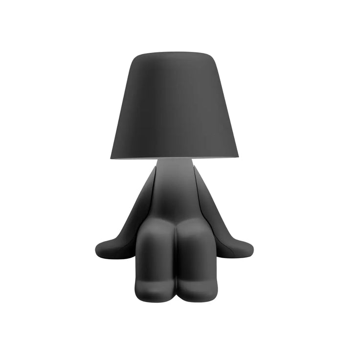 Lampada nera a forma di personaggio stilizzato seduto, con la testa a paralume