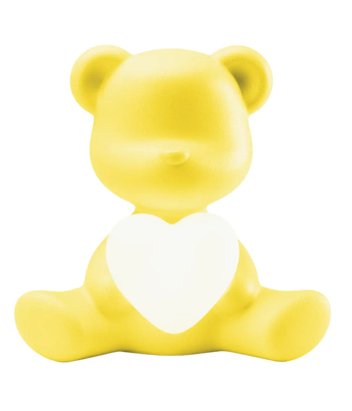 Lampada a forma di orsetto giallo con cuore che s'illumina al centro di Qeeboo