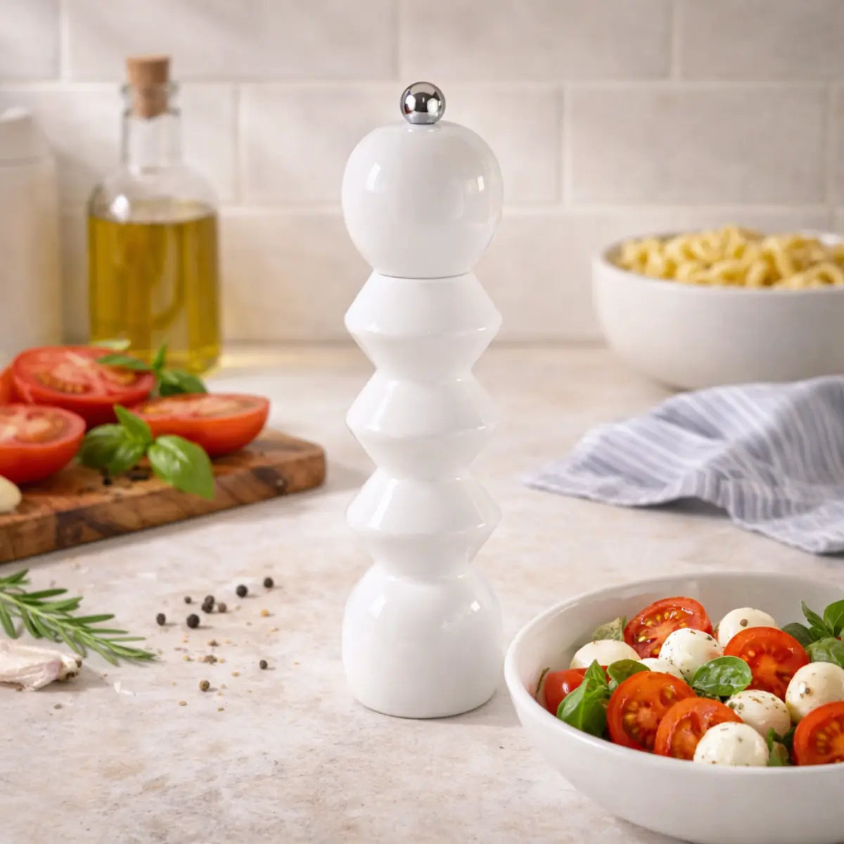 Macinapepe in legno laccato bianco con forme geometriche posizionato in una cucina