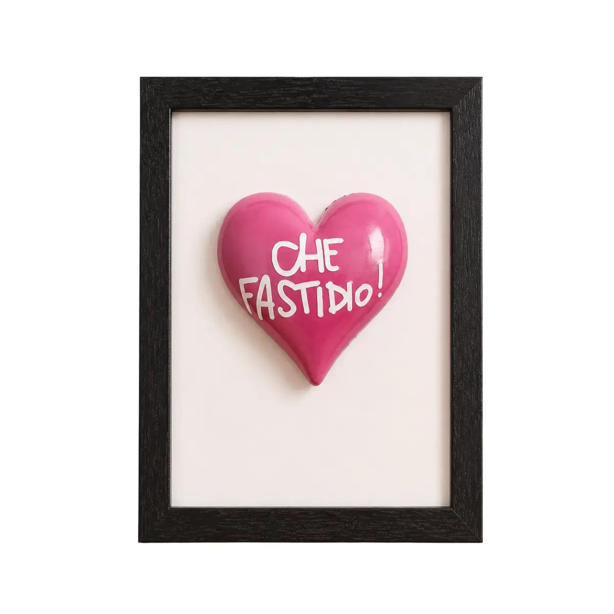 Quadretto realizzato a mano in Italia con cornice nera e al centro un cuore rosa con scritta "che fastidio"