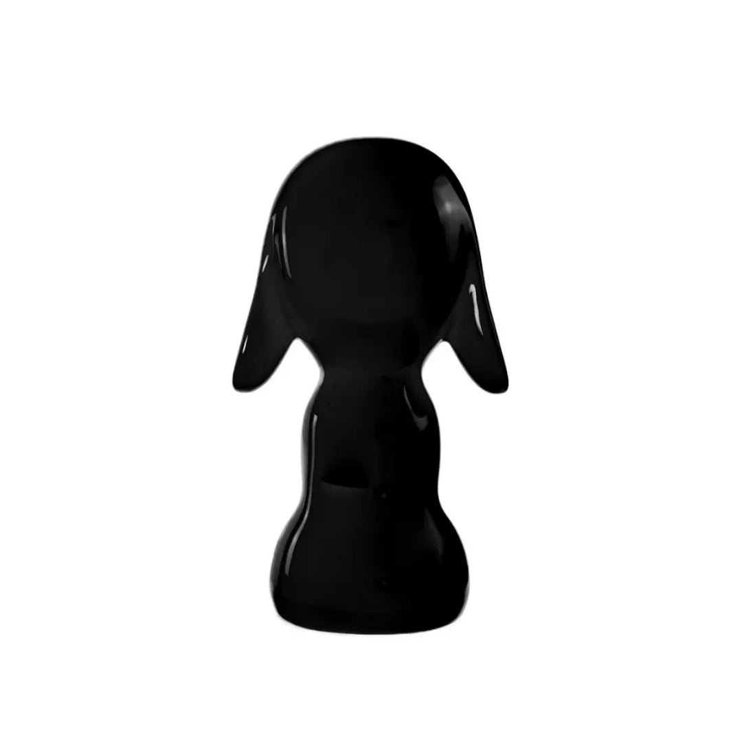 Retro statua nera a forma di cane, con occhi naso e bocca. Sfondo bianco