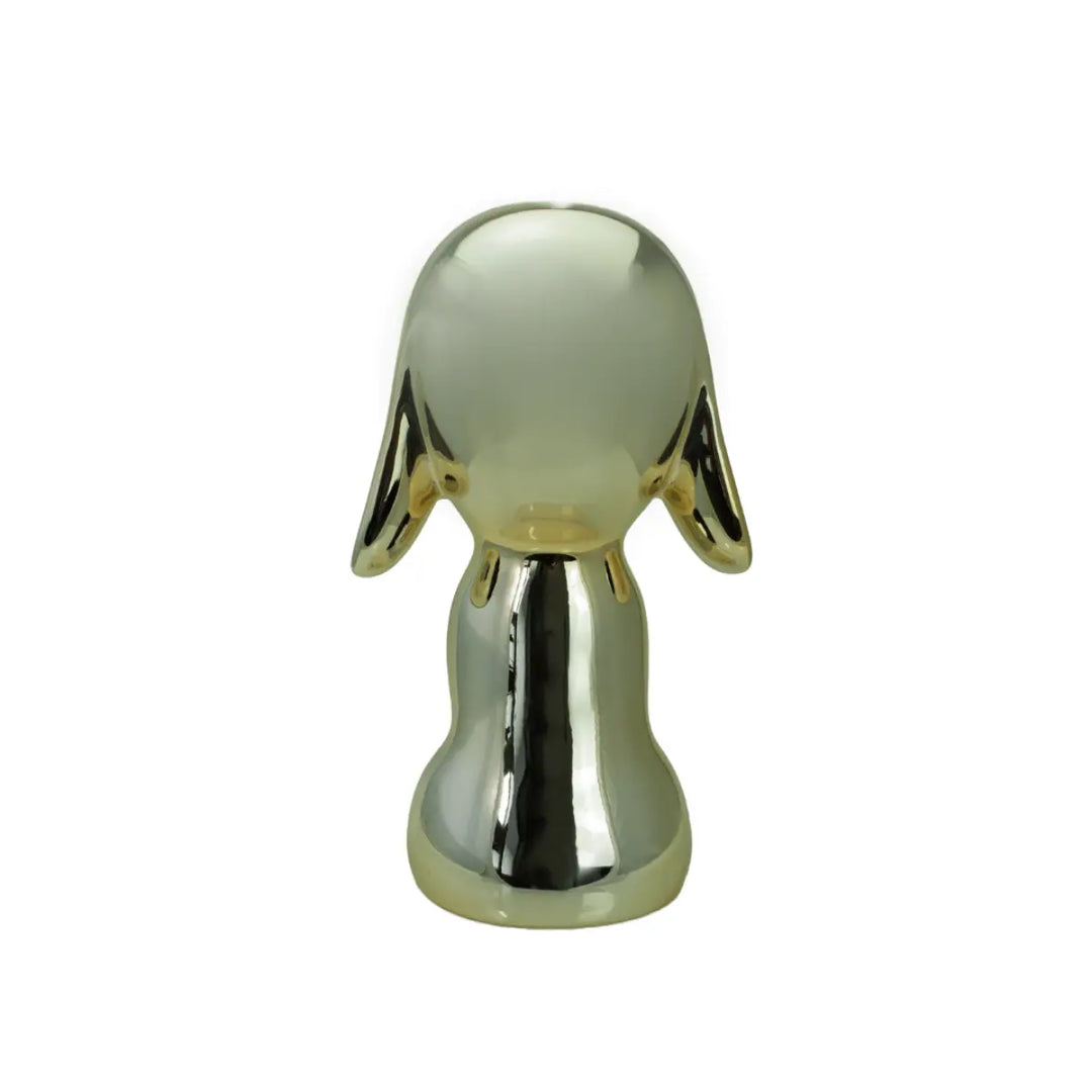 Retro statua oro a forma di cane, con occhi naso e bocca. Sfondo bianco