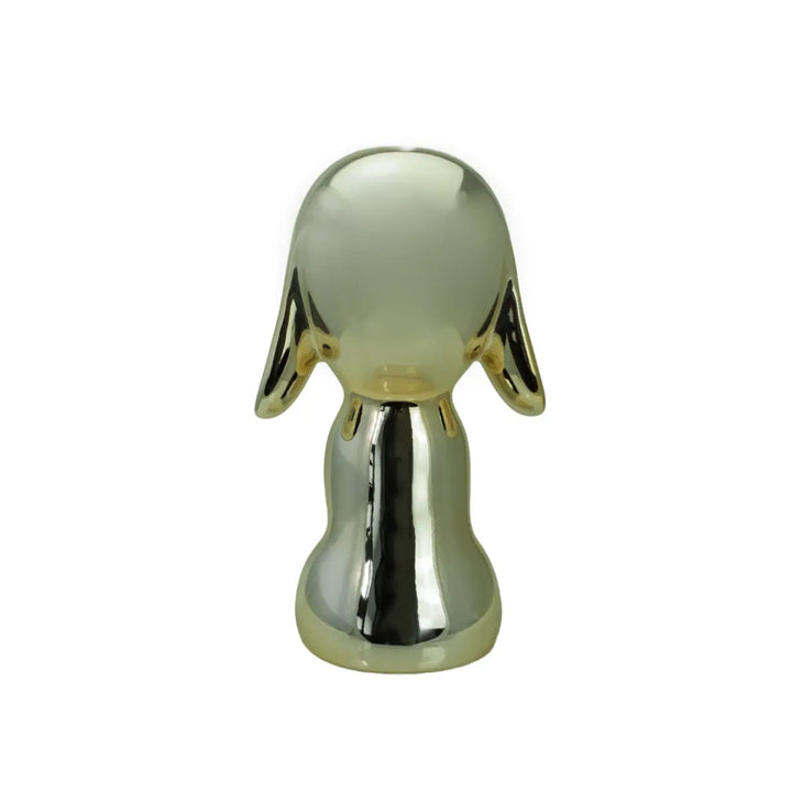 Retro statua oro a forma di cane, con occhi naso e bocca. Sfondo bianco