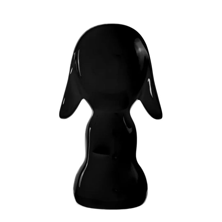 Retro statua nera a forma di cane, con occhi naso e bocca. Sfondo bianco