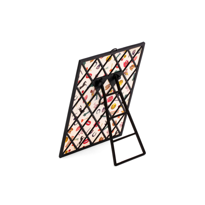 Retro dello specchio due di picche della collezione Toiletpaper di Seletti. Presente il supporto in plastica nera e un pattern contenente tutti i simboli iconici della collezione Toiletpaper