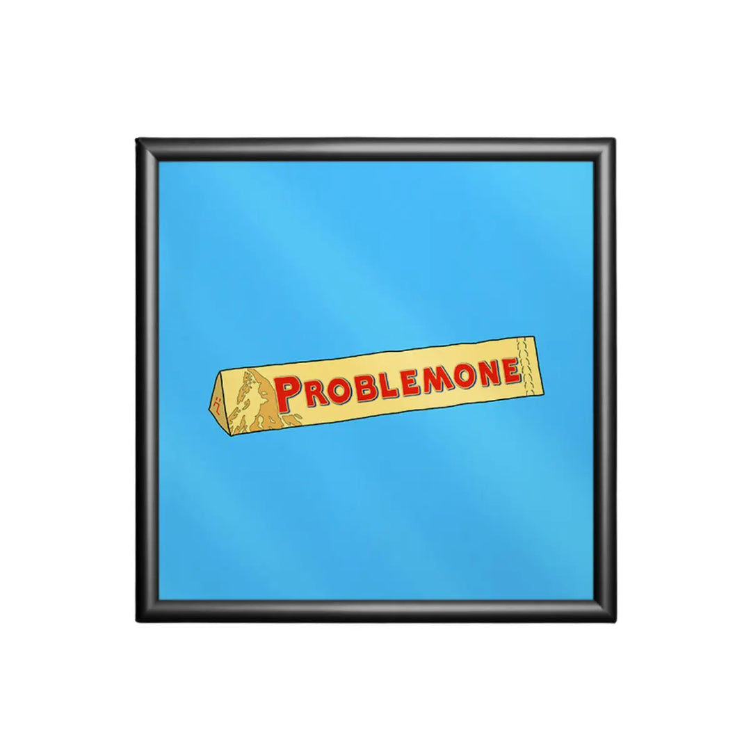 Stampa su sfondo azzurro con una confezione di torrone e la scritta ironica problemone con cornice nera