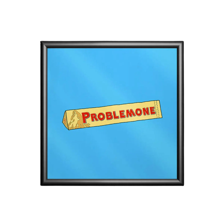 Stampa su sfondo azzurro con una confezione di torrone e la scritta ironica problemone con cornice nera