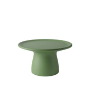 Tavolino basso verde a forma arrotondata che ricorda un fungo con base ampia 